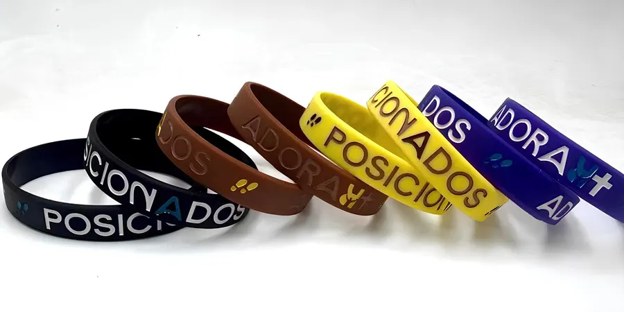 Pulseiras de silicone personalizadas lado a lado, mostrando cores e textos variados.